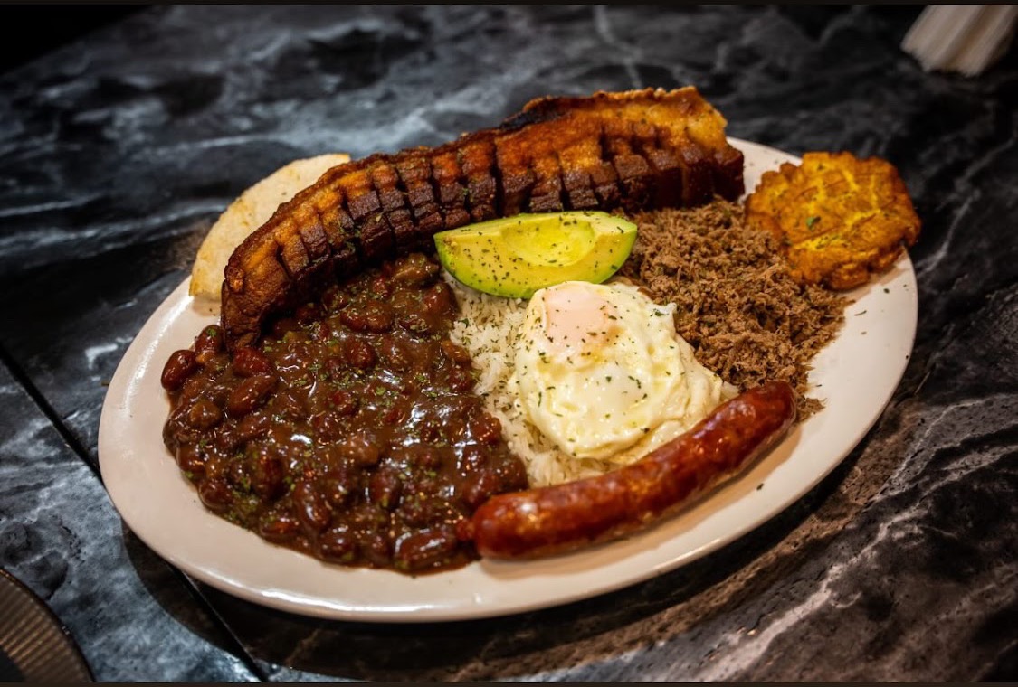 Bandeja paisa with red beans, rice, chicharrón, chorizo, fried egg, plantain and avocado